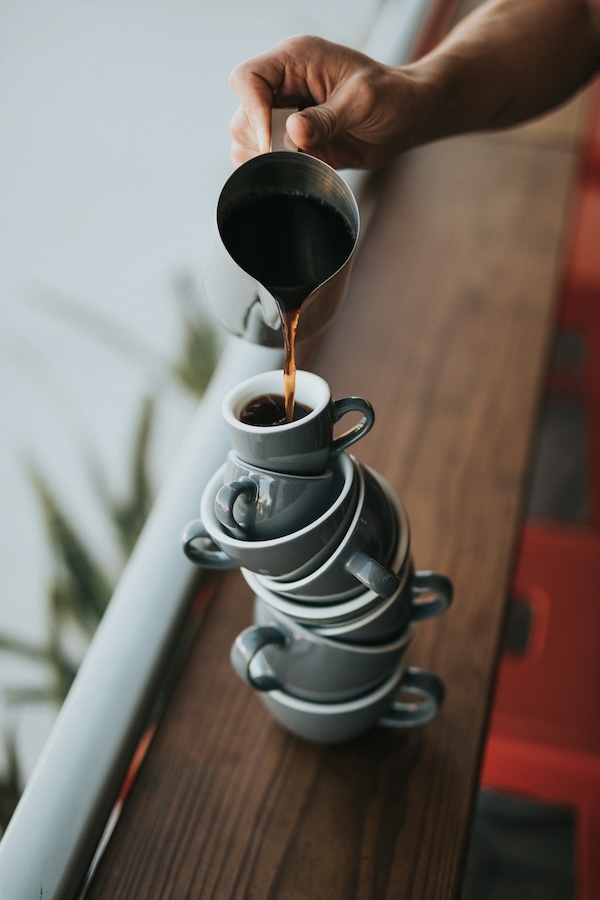 Coffee being poured by a window